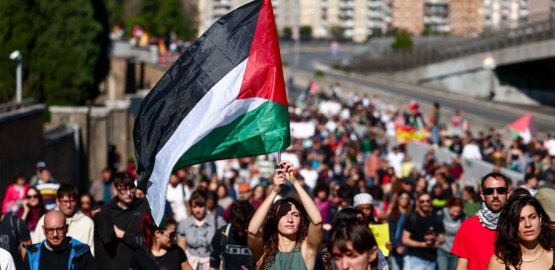 Una ragazza sventola la bandiera palestinese durante una manifestazione