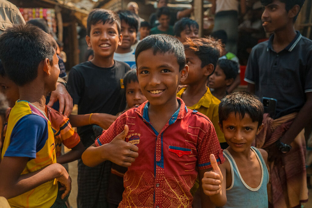 Bambini Rohingya, fissano l'obiettivo con il pollice della mano alzato. Sono sorridenti e pieni di vita, nonostate la loro situazione di rifugiati nel campo di Cox's Bazar in Bangladesh.