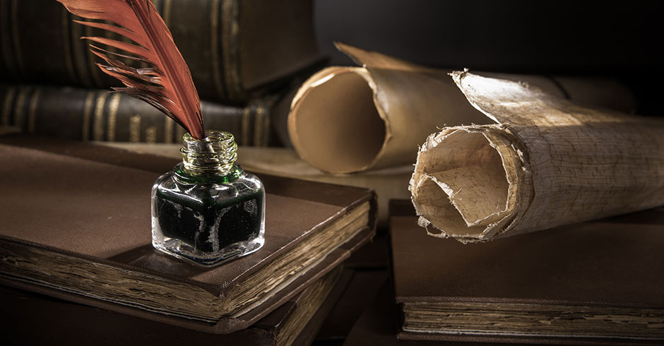 Alter Sekretär mit Federkiel, alten Papierrollen und in Leder eingefassten Büchern | Credit: iStock.com/siculodoc