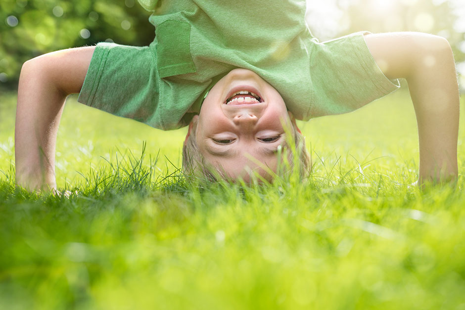 Ein Junge macht einen Kopfstand | Credit: iStock.com/BrianAJackson