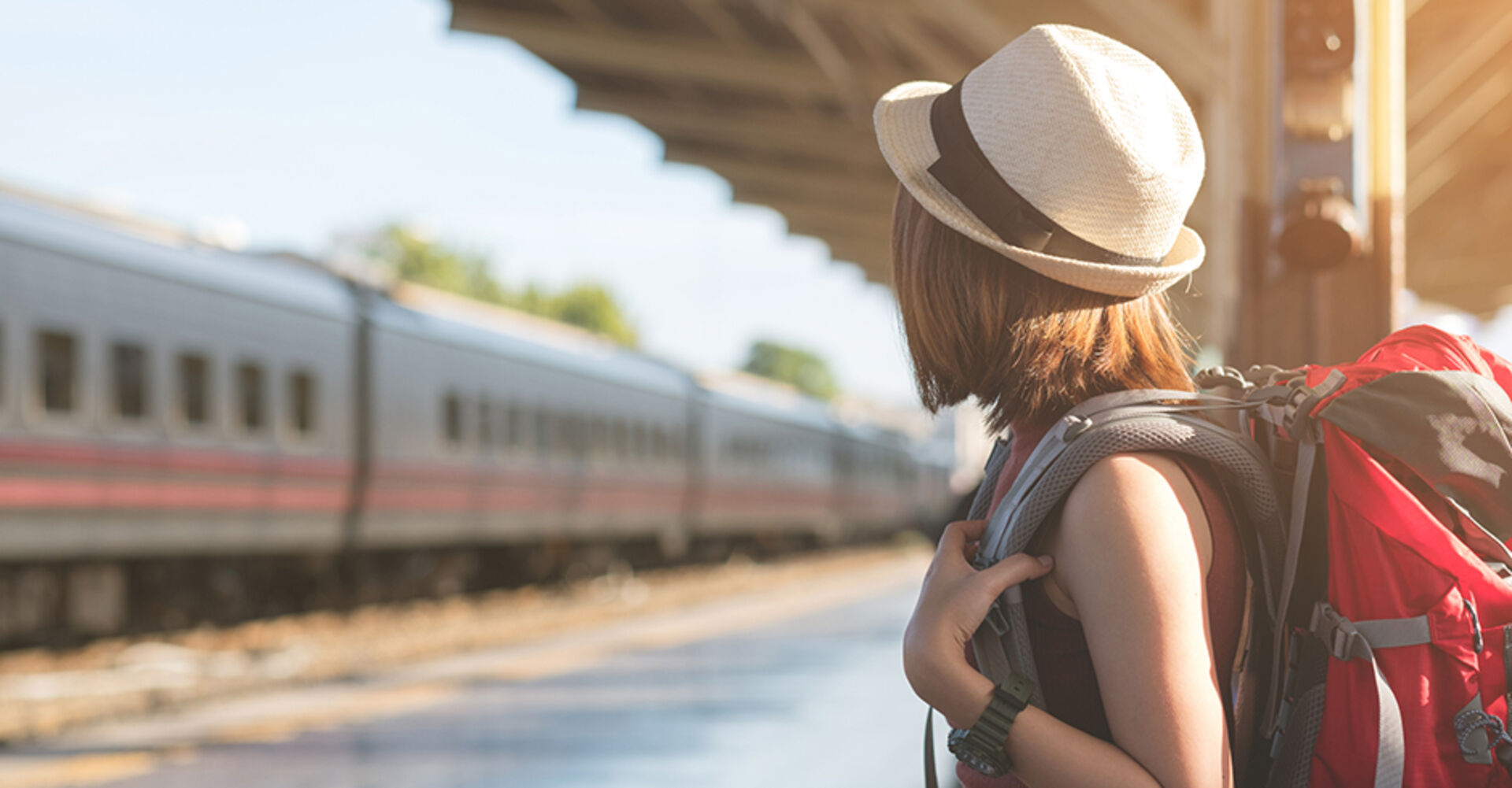 Eine junge Urlauberin wartet auf ihren Zug | Credit: iStock.com/structuresxx