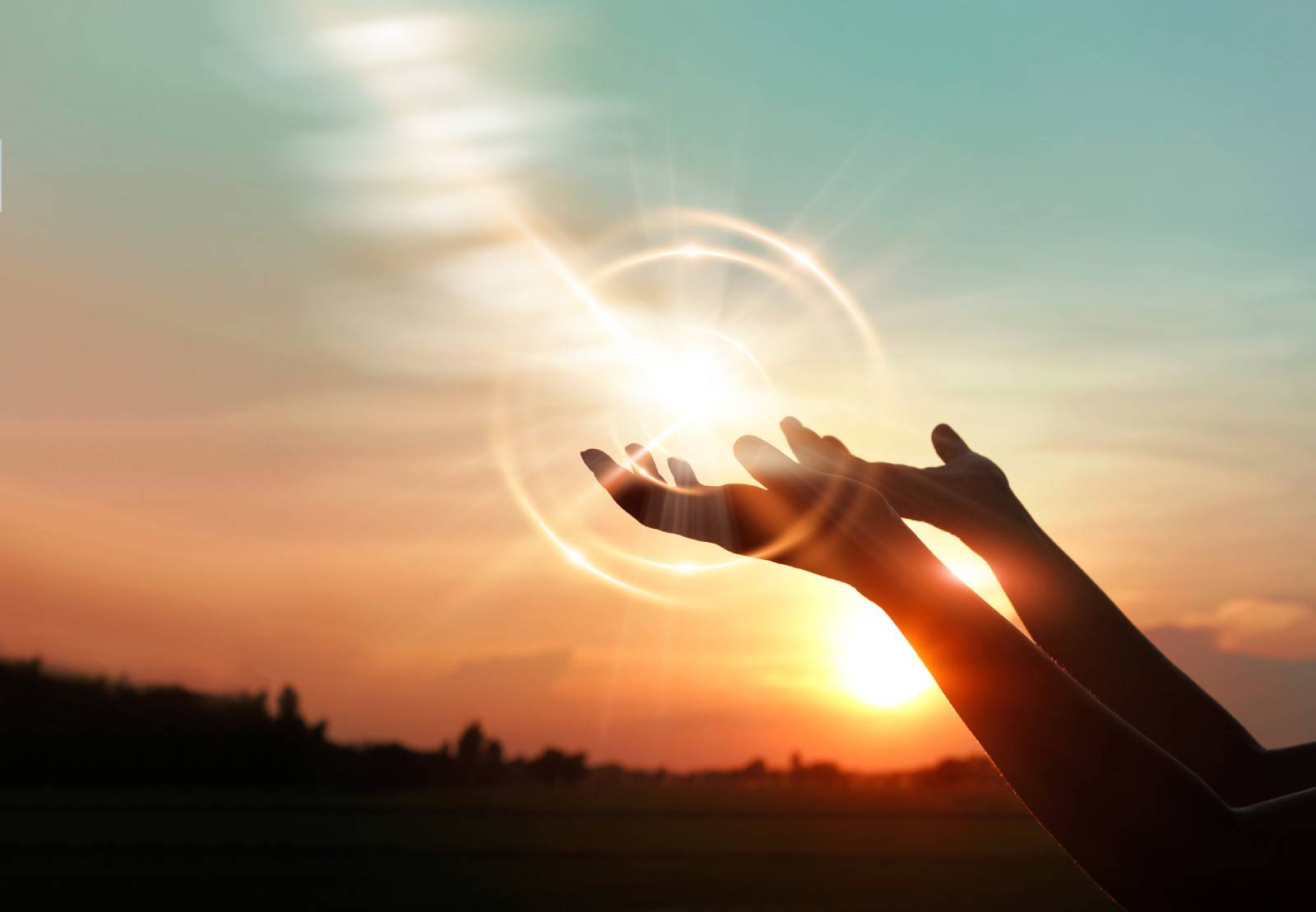 Junge Frau erhebt ihre Hände gegen den Himmel | Credit: iStock.com/ipopba