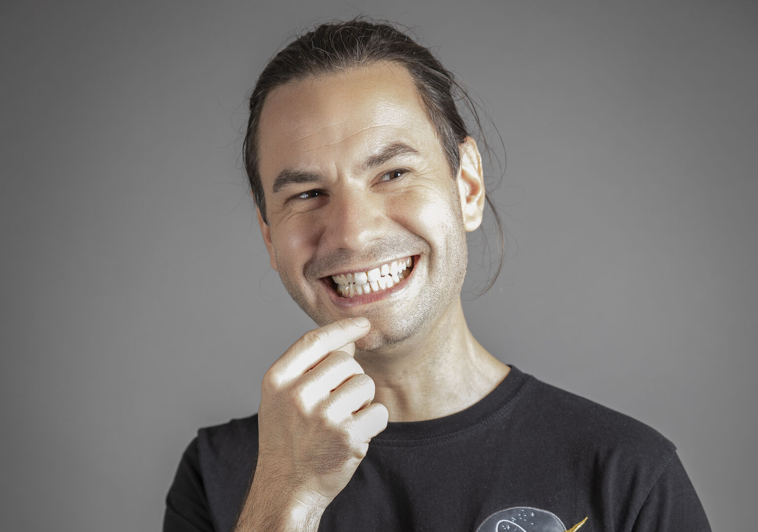 Porträt, lachend, eine Hand am Kinn