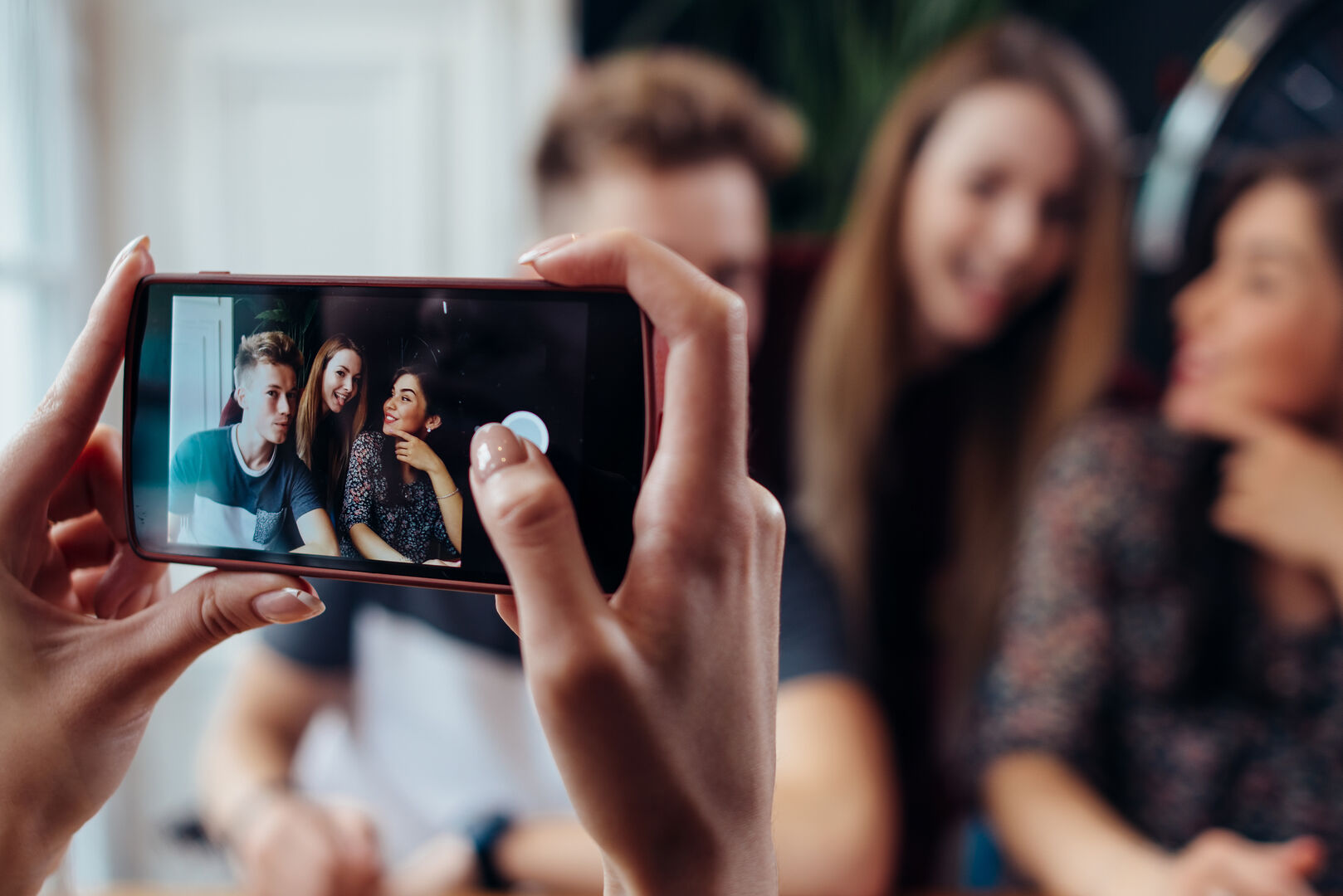 Drei Teenager werden mit dem Handy gefilmt