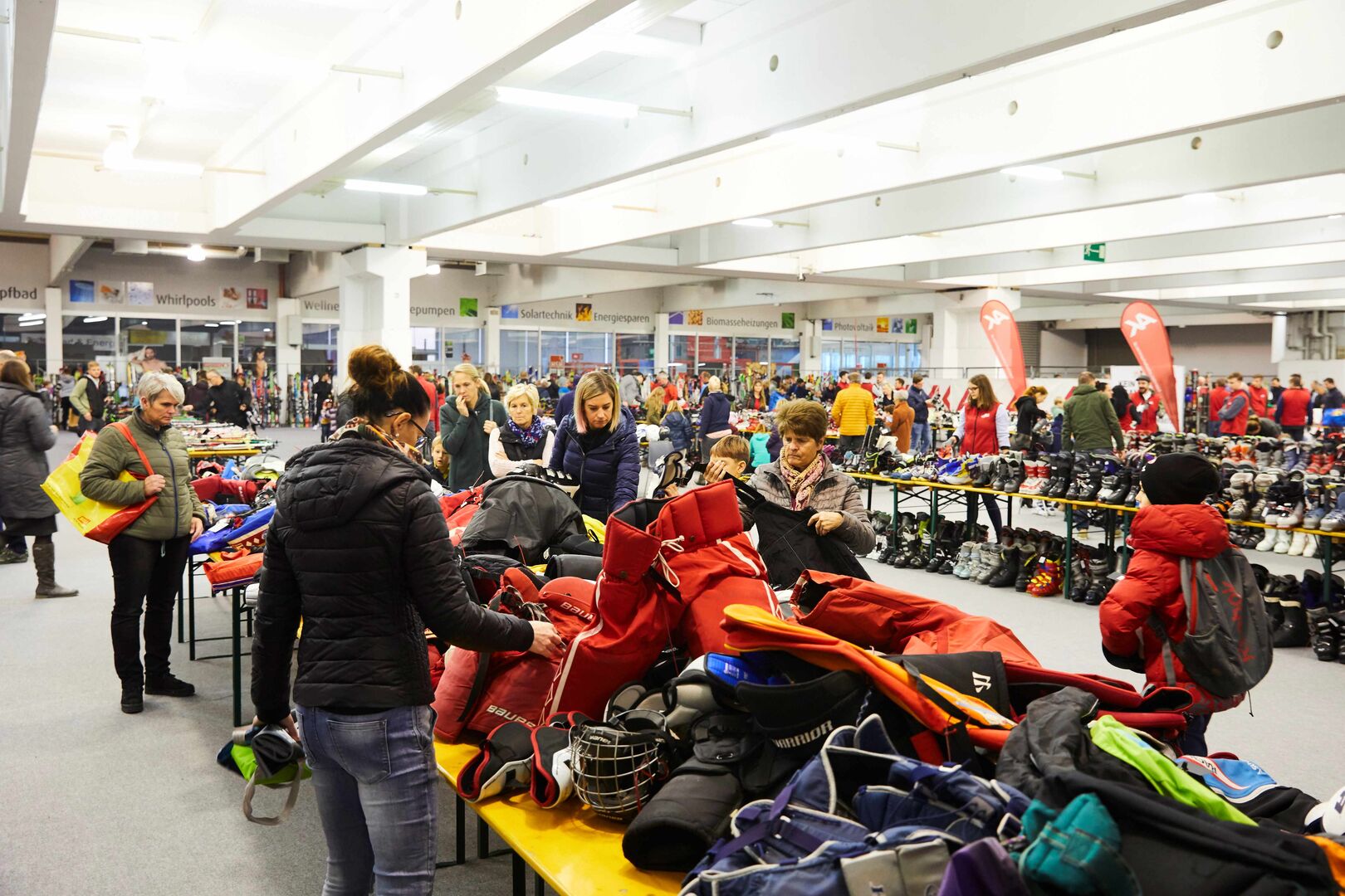 Wintersportbörse der AK - Menschen schauen sich Markttische mit Produkten an in Halle