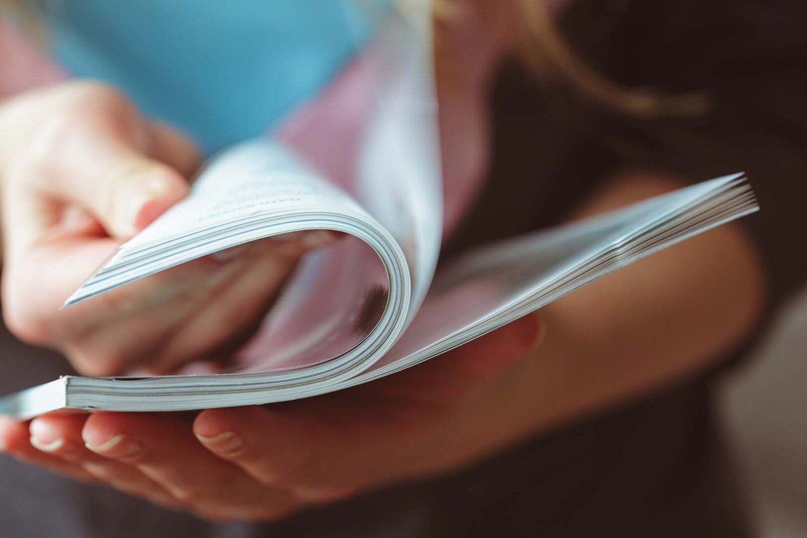 Frau blättert in Zeitschrift | Credit: iStock.com/FabrikaCr