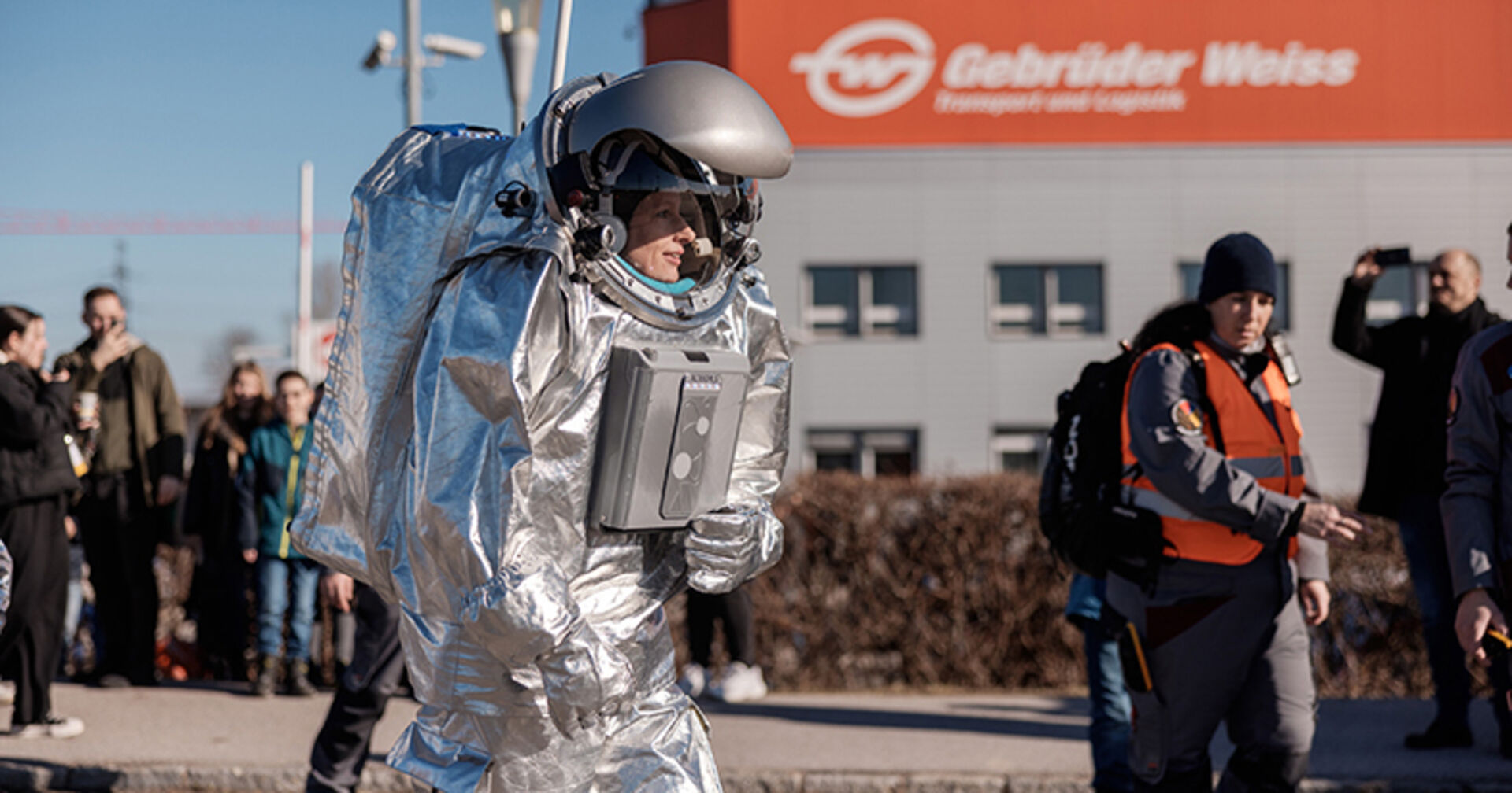 Analog-Astronautin Carmen Köhler begeistert Mitarbeiter:innen und Medien bei ihrem Rundgang im Raumanzug.