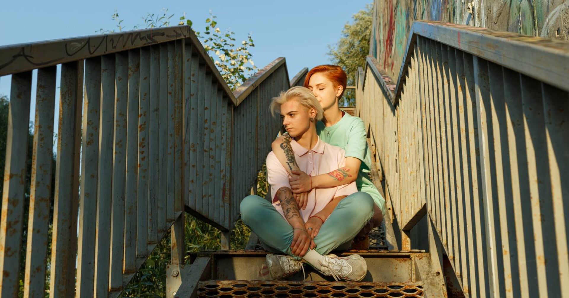 Ein Paar sitzt eng aneinandergekuschelt auf einer Treppe.