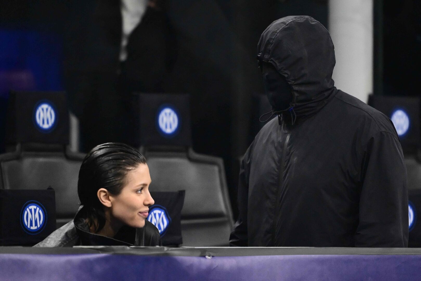 Bianca Censori und Kanye West bei einem Sport-Event. Kanye ist komplett verkleidet und zeigt sich nicht.