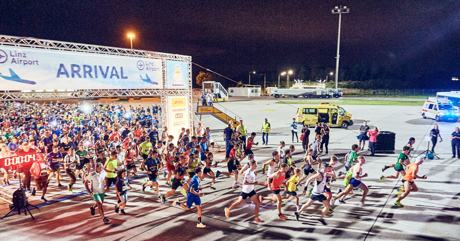 Läuferinnen und Läufer am Start des DHL Linz Airport NIGHT RUN 2024 | Credit: Soul Space Studios