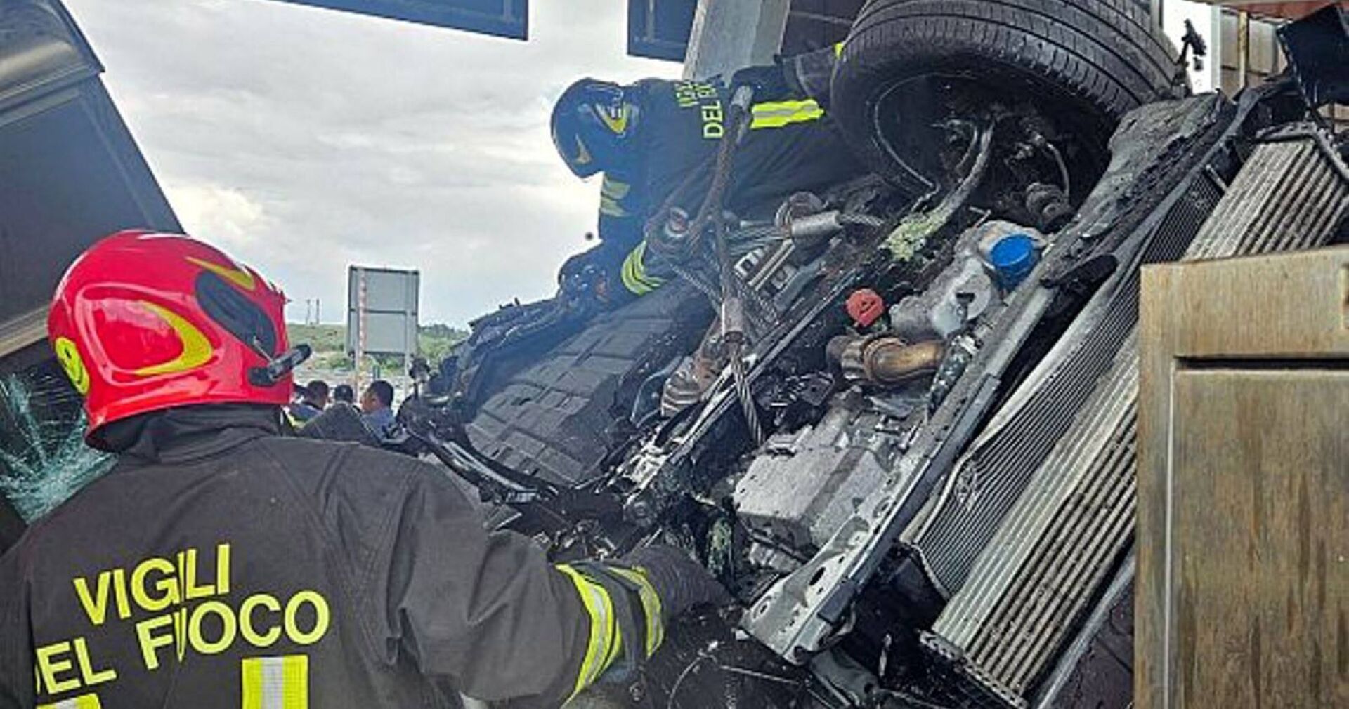 Feuerwehrleute im Einsatz, der Unfallwagen im Hintergrund.