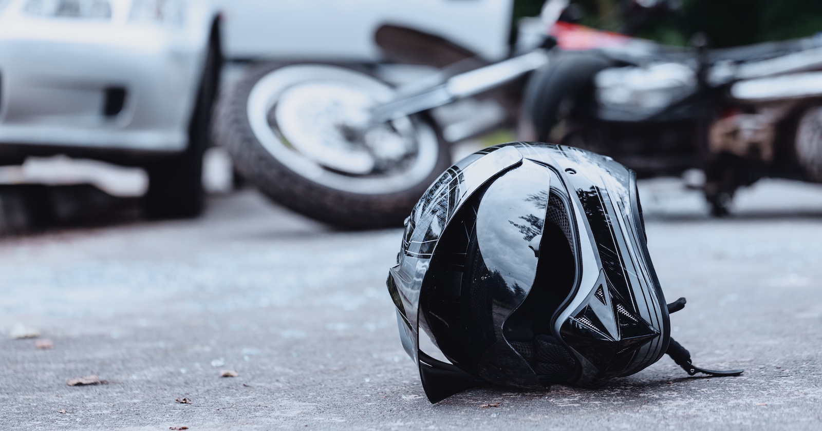 Der Helm eines Motorradfahrers liegt nach einem Unfall auf der Straße.