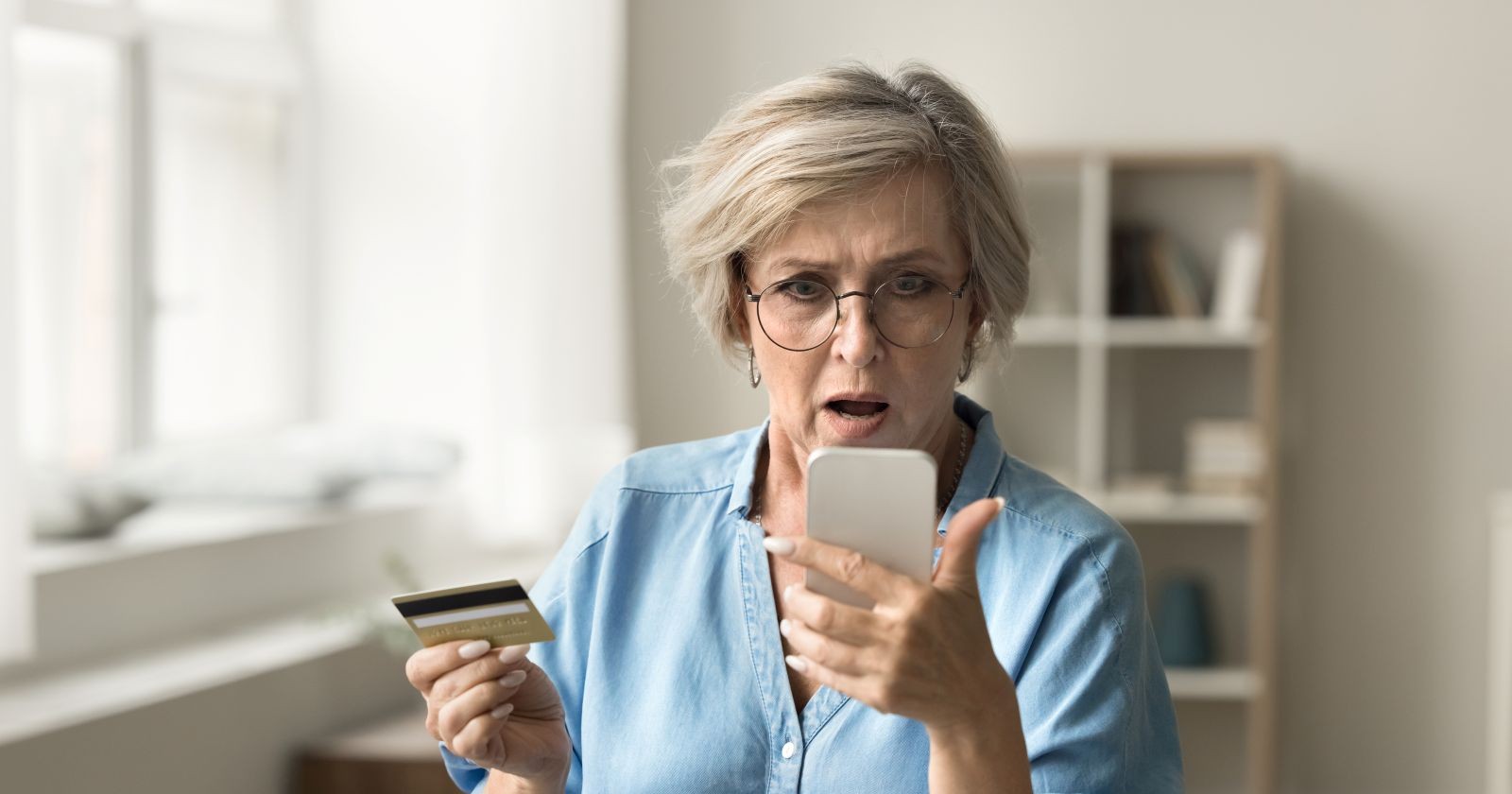 Frau starrt entgeistert auf ihr Smartphone