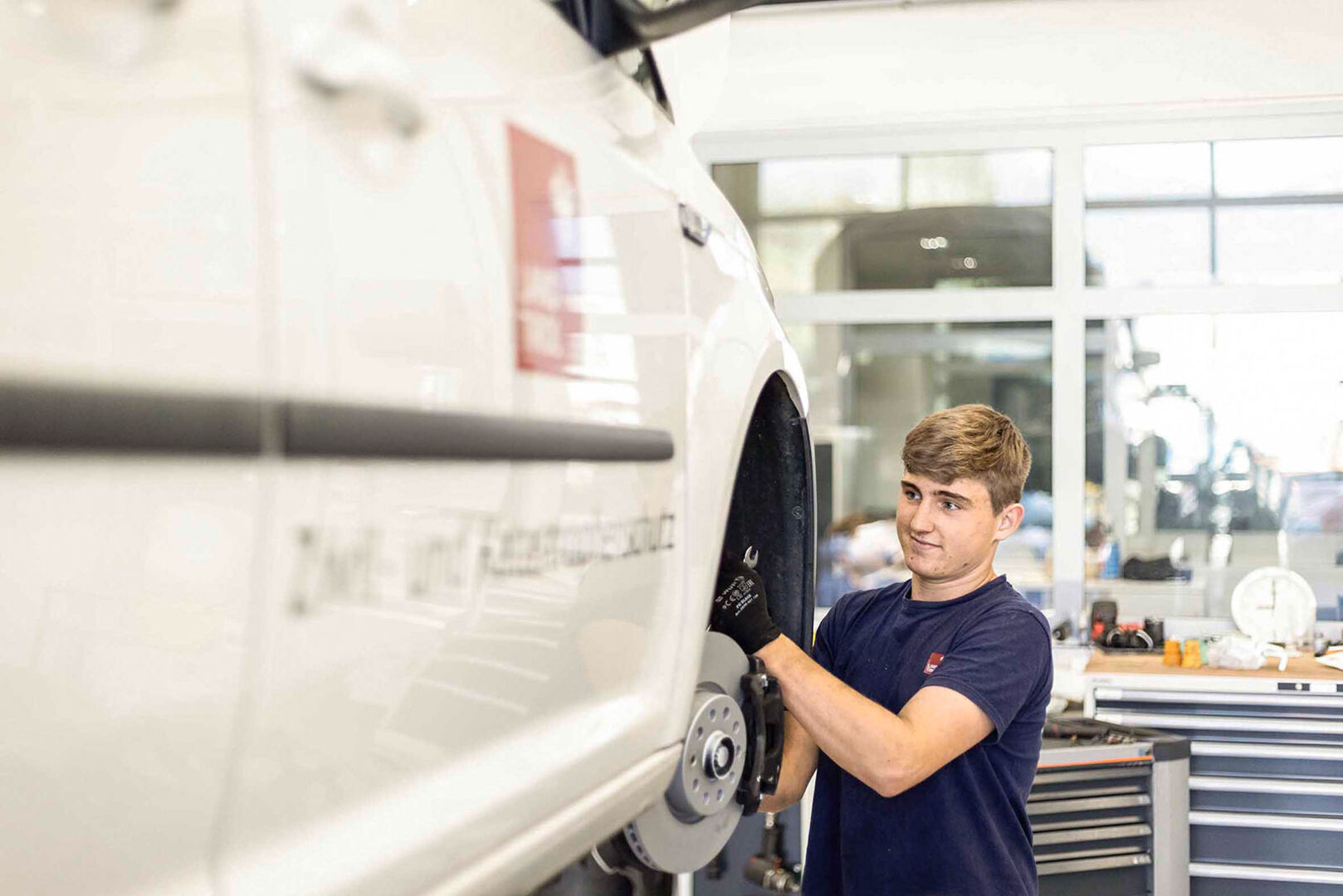 Junger Mann bei dem Reifenwechsel | Credit: Land Tirol/Charly Schwarz und Simon Rainer