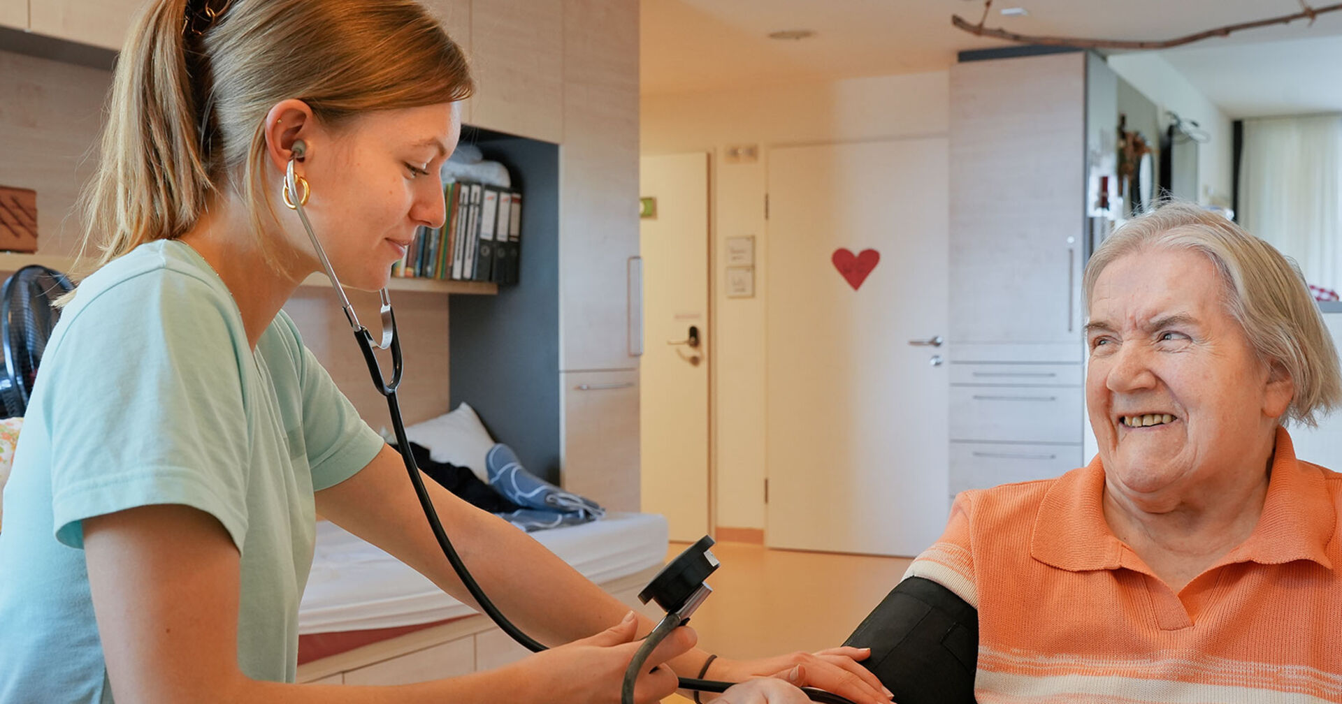 Junge Pflegerin misst bei Seniorin den Blutdruck | Credit: SHV Kirchdorf