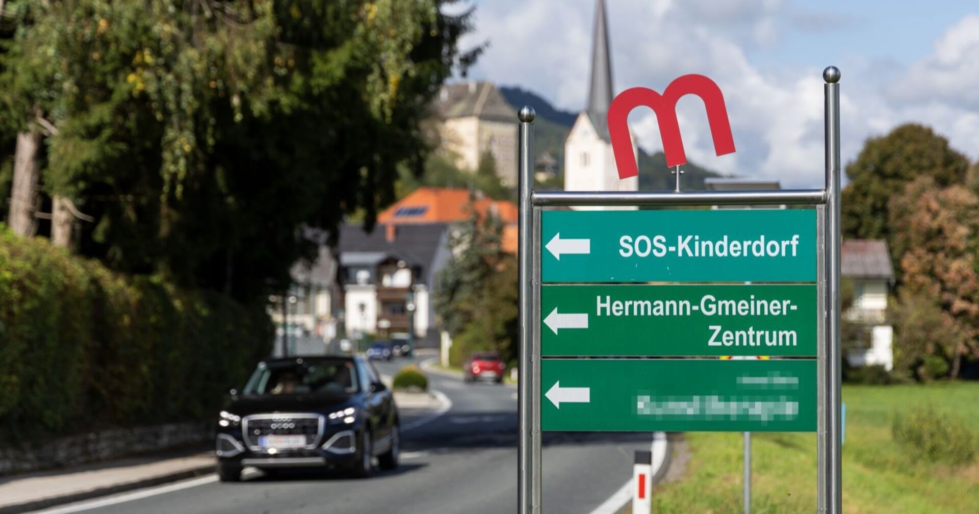SOS-Kinderdorf Schild auf Straße