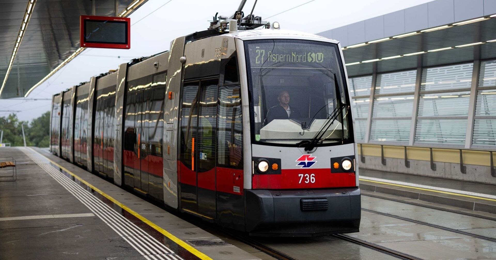 Premierenfahrt der Straßenbahnlinie 27 mit beschriftetem ULF-Zug der Firma Siemens auf der neu errichteten Statrion "Aspern Nord"