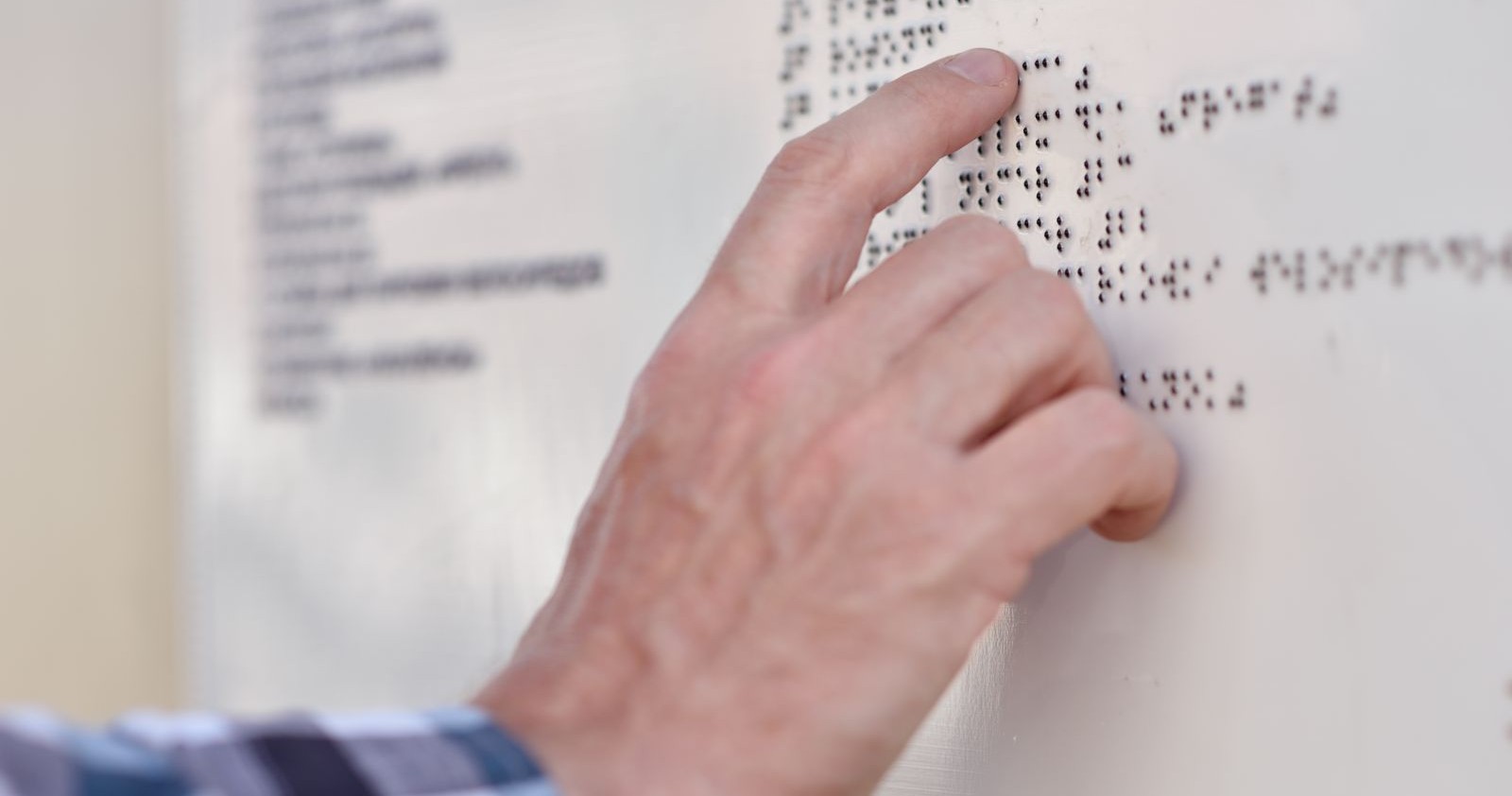Jemand liest mit der Hand Blindenschrift.