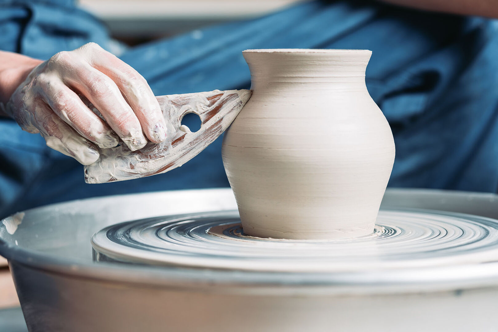 Frau töpfert eine Vase | Credit: iStock.com/Wirestock