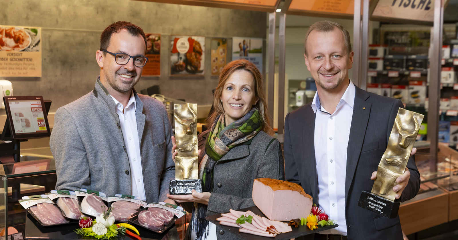 Drei Menschen lächeln in die Kamera