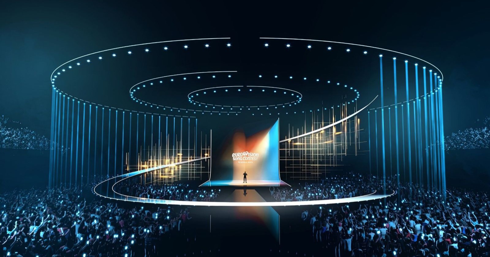 Futuristische Bühne des Eurovision Song Contest 2026 in Wien mit leuchtenden Lichtkreisen, LED-Effekten und großem Publikum in einer modernen Arena.