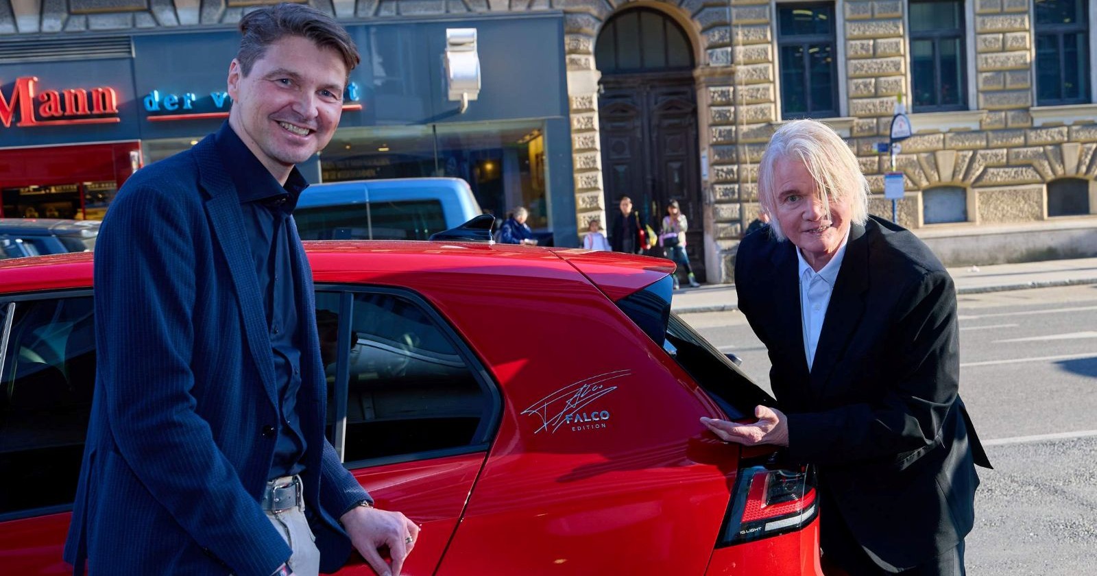 Zwei Männer vor einem roten VW-Golf