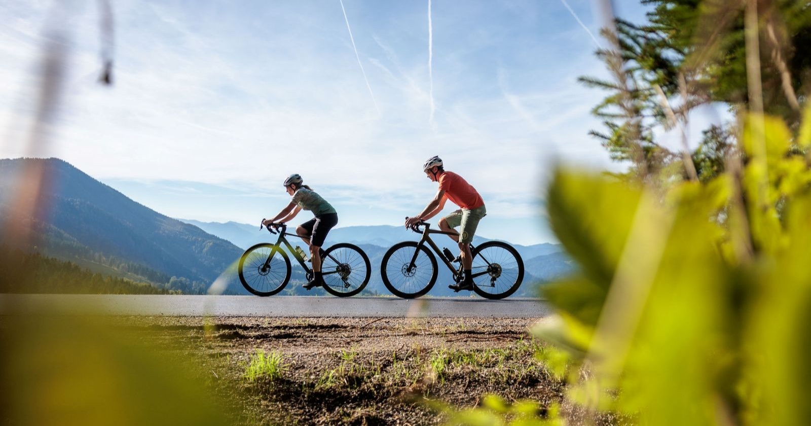 Zwei Menschen fahren auf Rädern durch die Landschaft