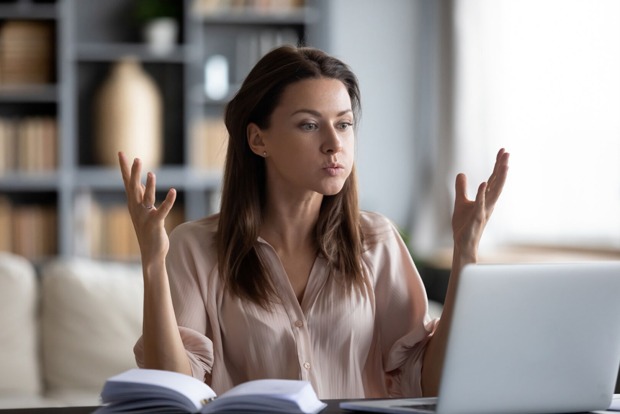 Frau sitzt entnervt vor ihrem Notebook | Credit: iStock.com/fizkes