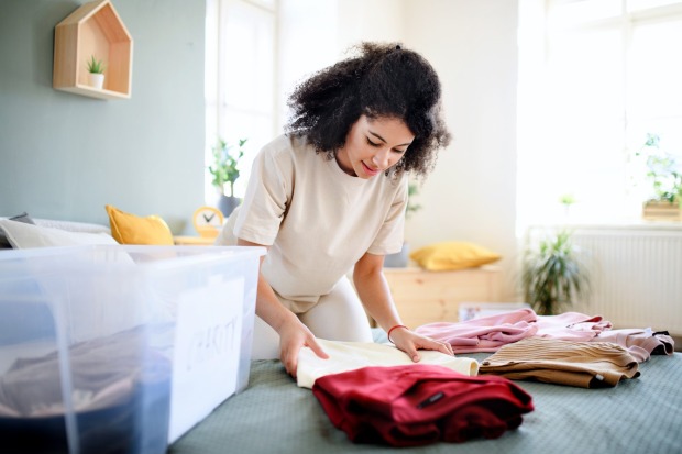Frau ordnet ihre Kleidung | Credit: iStock.com/Halfpoint