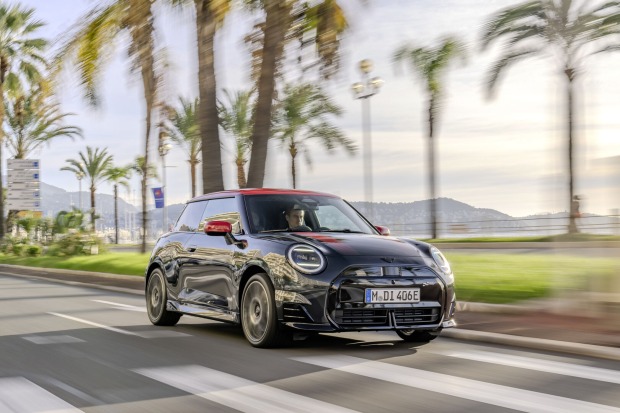 Zum Look des Cooper SE im JCW Trim gehören Diffusoren im Front- und Heckbereich. Kühlergrilleinfassung und Logo sind in Hochglanz-Schwarz gehalten. Optische Highlights sind das Kontrastdach und die Spiegelkappen in Chili Red.