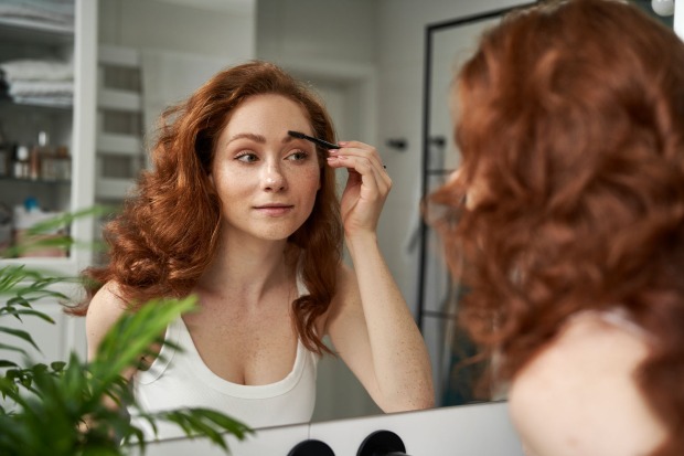 Frau bürstet ihre Augenbrauen | Credit: iStock.com/gpointstudio