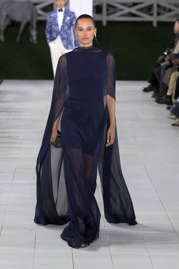 Model in einem dunkelblauen Kleid am Laufsteg