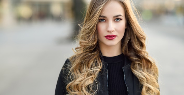 PORTRÄT EINER JUNGEN FRAU MIT LANGEN BLONDEN, LOCKIGEN hAAREN