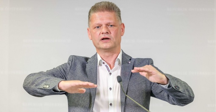 Andreas Hanger steht vor einem Rednerpult, spricht und gestikuliert