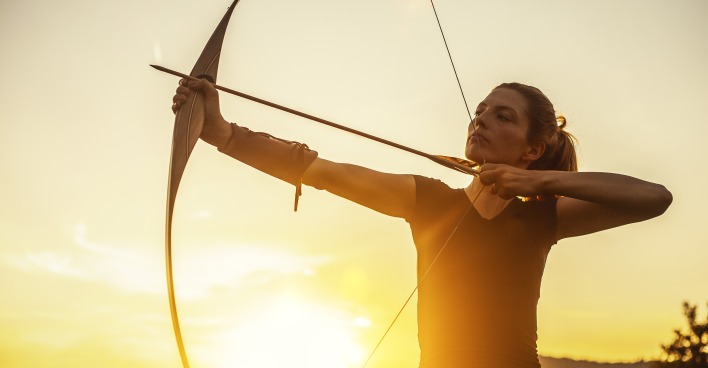 Frau mit Bogen im Sonnenuntergang