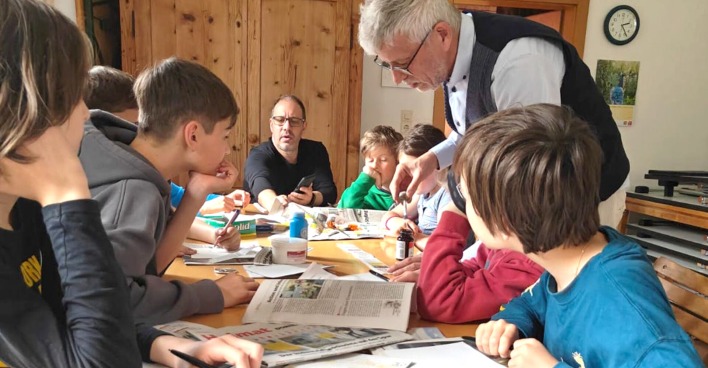 Vereinsgründer Jürgen Peter zeigt im Jugendworkshop, wie Zaubertricks mit Zeitungen vorbereitet werden.
