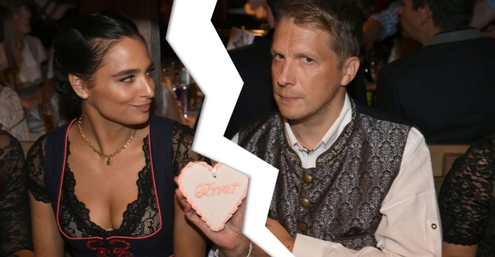 Oliver und Amira Pocher beim Oktoberfest. Er hält ein Lebkuchen Herz mit "Oliver". Zwischen ihnen wurde mit Photoshop ein Blitz eingefügt, da sie sich in Scheidung befinden.