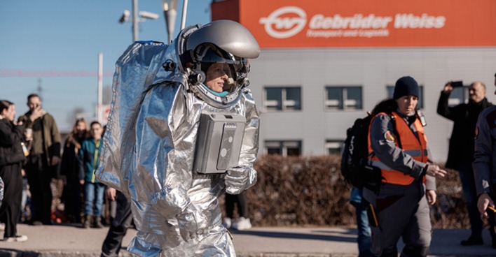 Analog-Astronautin Carmen Köhler begeistert Mitarbeiter:innen und Medien bei ihrem Rundgang im Raumanzug.