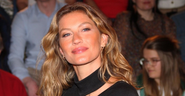 Gisele Bündchen mit offenen blonden Haaren und einem schwarzen Top.
