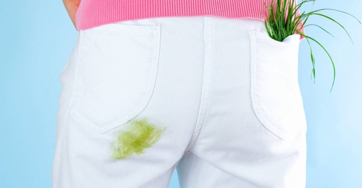 Detailansicht einer weißen Hose mit grünem Grasfleck über dem Gesäß.