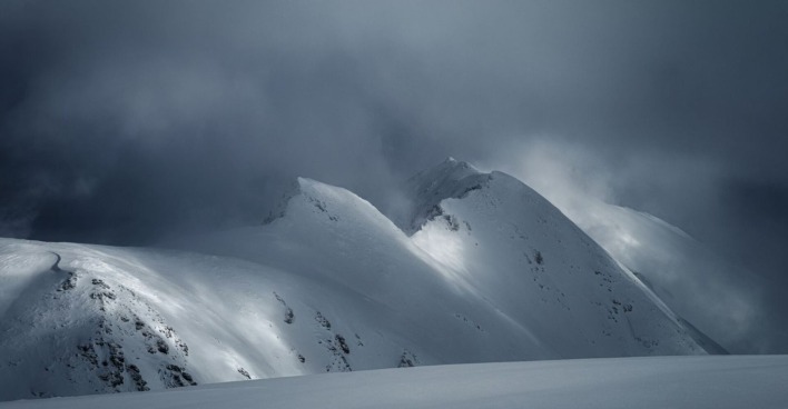 Ein düsteres Bild von einem schneebedeckten Berg.