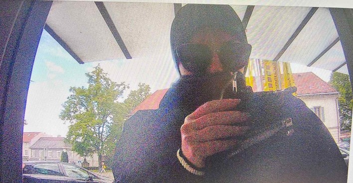 Bild aus einer Überwachungskamera, wie die Frau Geld abhebt.