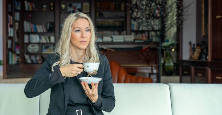 Simone Lugner mit einer Tasse auf der Couch