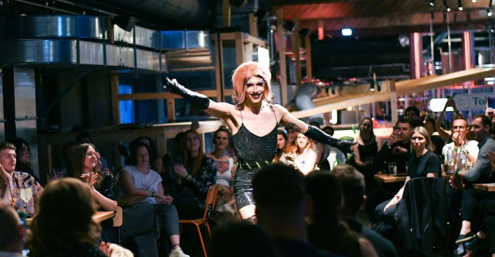 Dra Queen breitet mitten im Publikum die Arme aus