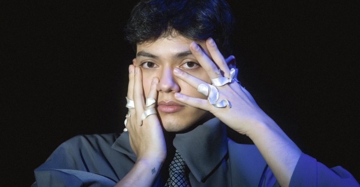 Sänger JJ hält die ringbesetzten Finger an seine Gesichtswangen
