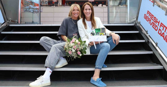 Zwei Frauen sitzen nebeneinander auf einer Treppe