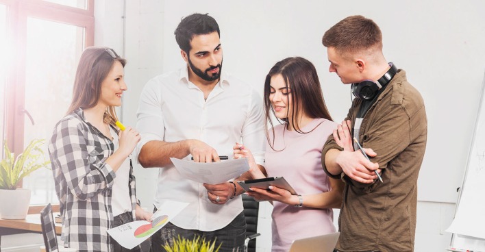 Gruppe von Mitarbeitenden berät miteinander weiteres Vorgehen | Credit: Adobe Stock/proimagecontent