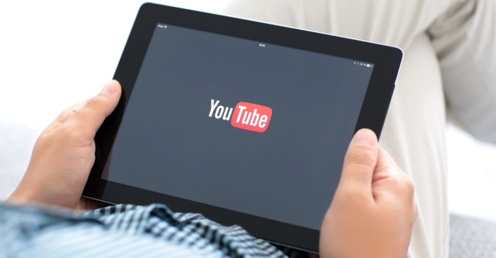 Mann mit der ladenden YouTube-App auf einem iPad