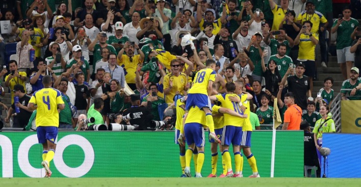Schwedische Spieler feiern ein Tor vor jubelnden Fans im Stadion während des WM-Spiels gegen Tunesien