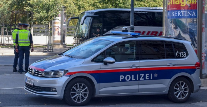 Polizeiauto und Beamte im Einsatz in Wien-Donaustadt nach tödlicher Prügelattacke mit festgenommenem Verdächtigen